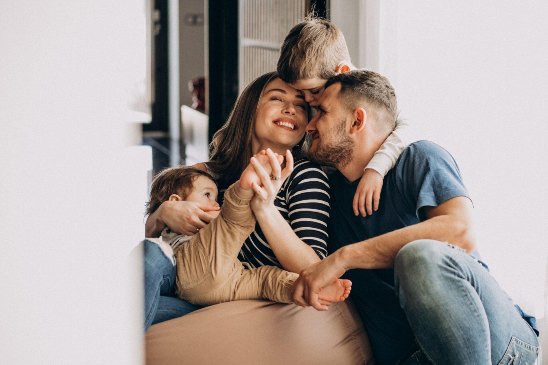 Young family with their sons at home having fun young family with kids