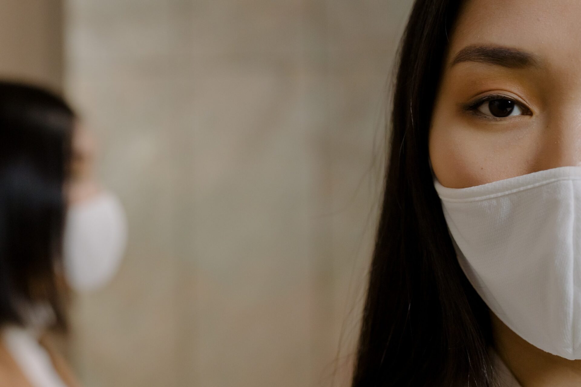 Woman staring at audience with mask on