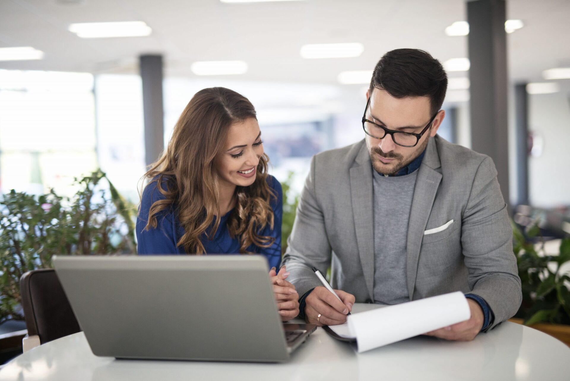 Young business people in modern office working on a solution and Young business people in modern office working on a solution and