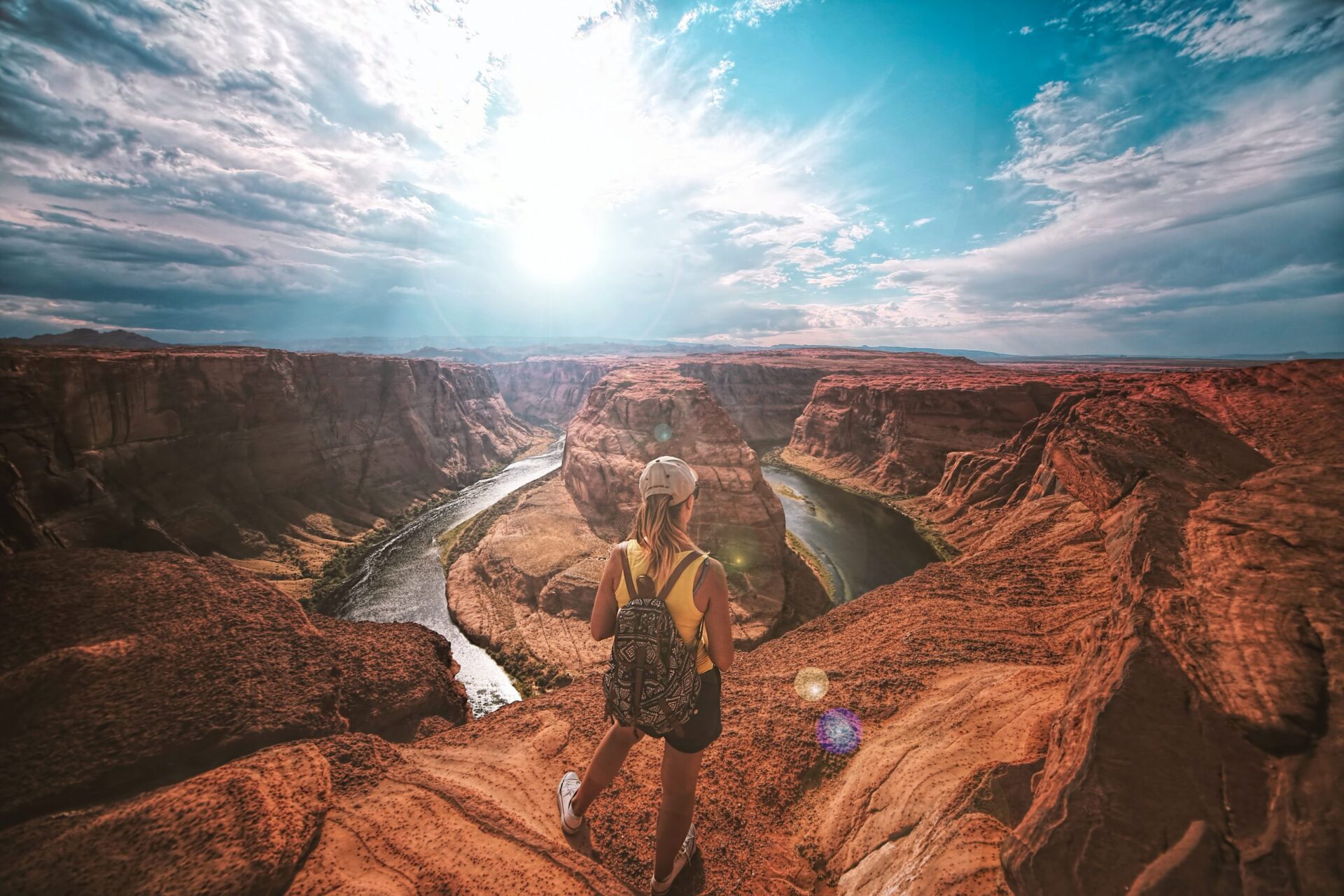 Woman on the edge of a mountain gazing at the scenery