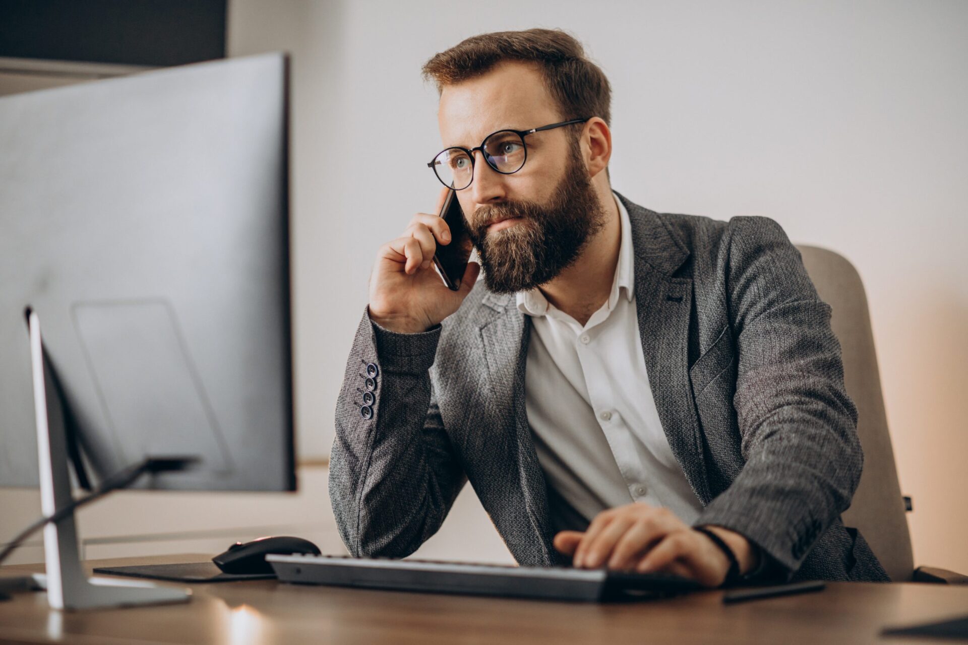 Business talking on phone and working simultaneously