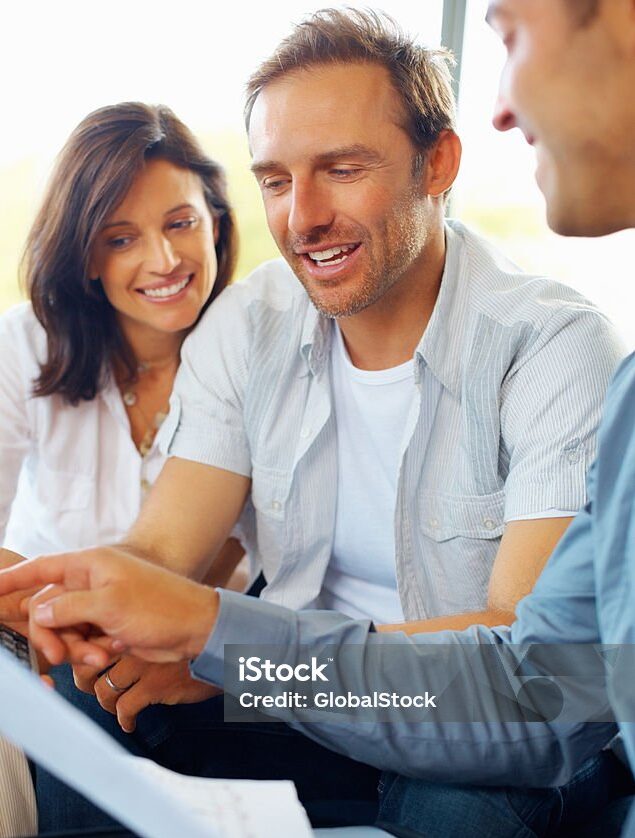 Happy mature couple discussing financial matter with advisor